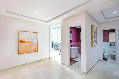 a white room with a painting on the wall at Migdal Jaouhara in Marrakech