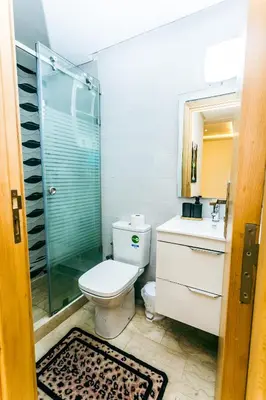 a bathroom with a toilet and a glass shower at Migdal Jaouhara in Marrakech