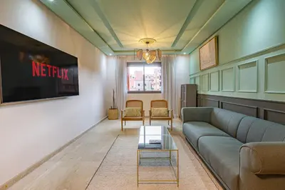 a living room with a couch and a tv at Migdal Jaouhara in Marrakech