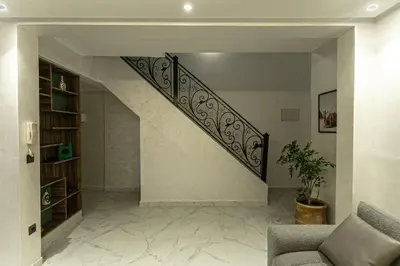 a staircase in a living room with a couch at Duplex Majorella in Marrakech