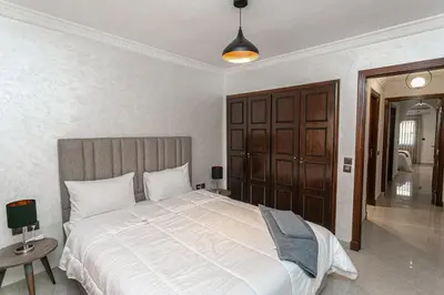 a bedroom with a large bed in a room at Duplex Majorella in Marrakech