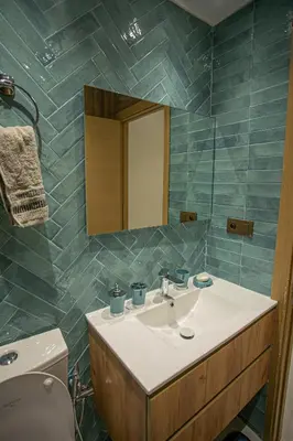 a bathroom with a sink and a mirror and a toilet at Duplex Majorella in Marrakech