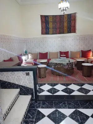 a living room with a couch and a table at Riad avec jardins et piscines in Marrakech