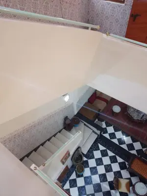 an open drawer in a kitchen with a checkered floor at Riad avec jardins et piscines in Marrakech