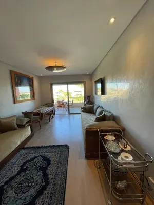 a living room with a couch and a table at Prestigia golf in Marrakech