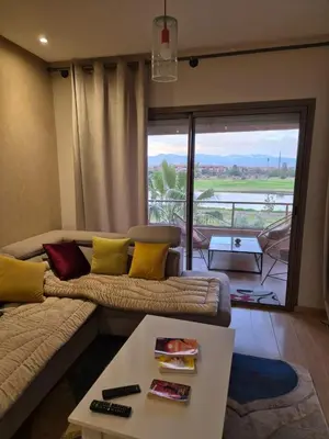 a living room with a couch and a table at Prestigia golf in Marrakech