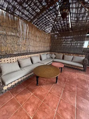 a living room with a couch and a table at Riad Naïel piscine privée in Marrakech