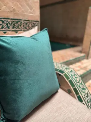 a green pillow sitting on top of a bed at Riad Naïel piscine privée in Marrakech