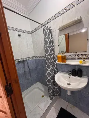 a bathroom with a sink and a shower at Riad Naïel piscine privée in Marrakech