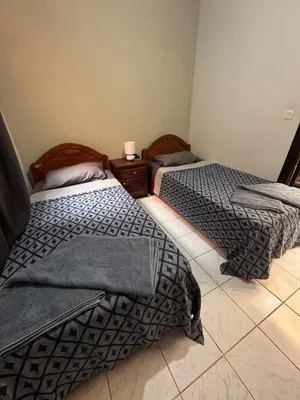 two beds sitting next to each other in a room at Riad Naïel piscine privée in Marrakech