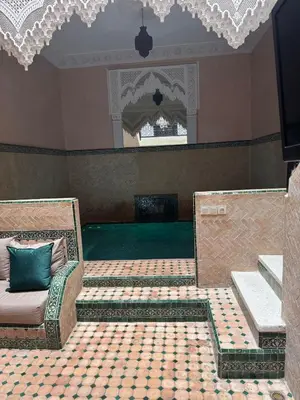 a living room with a couch and a mirror at Riad Naïel piscine privée in Marrakech