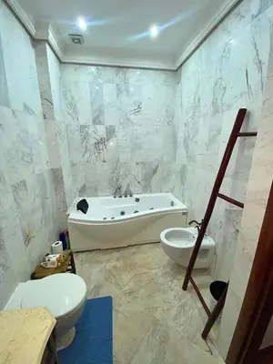 a bathroom with a tub and a toilet and a sink at Modern Gueliz Apartment with Private Pool, Near to Train Station in Marrakech
