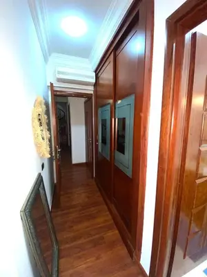 a hallway with wood floors and a hallway with doors at Modern Gueliz Apartment with Private Pool, Near to Train Station in Marrakech