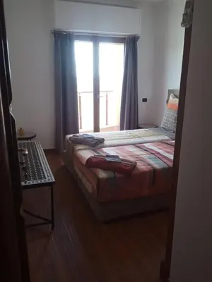a small bedroom with a bed and a window at Modern Gueliz Apartment with Private Pool, Near to Train Station in Marrakech