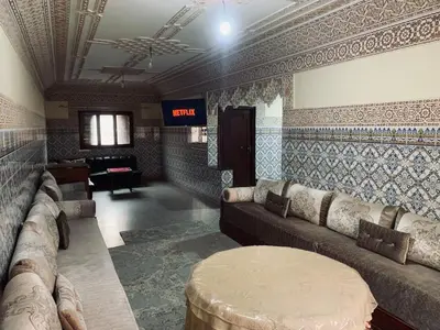 a living room with a couch and a table in it at 120m2, Centre Marrakech, Traditional in Marrakech