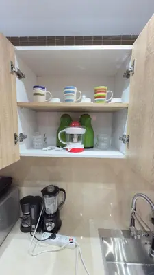 a kitchen shelf with dishes and a blender on it at Just renovated appartement in marrakech in Marrakech