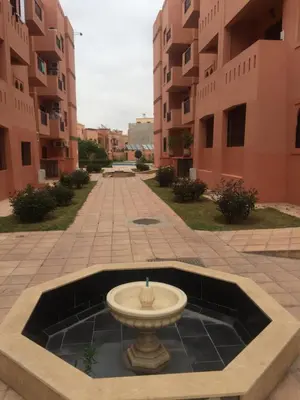 a fountain in the middle of a courtyard with buildings at Just renovated appartement in marrakech in Marrakech