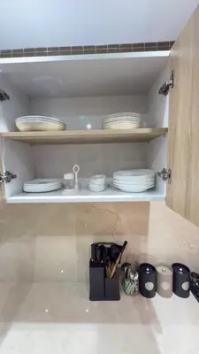 a cupboard with plates and dishes in it at Just renovated appartement in marrakech in Marrakech