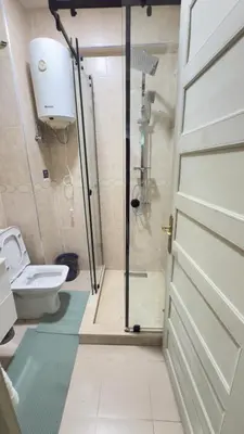 a bathroom with a shower and a toilet and a door at Just renovated appartement in marrakech in Marrakech