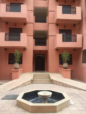 a building with a fountain in front of it at Just renovated appartement in marrakech in Marrakech