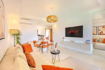 a living room with a couch and a table at Évasion à NORIA - Vue Piscine et Charme Local in Marrakech