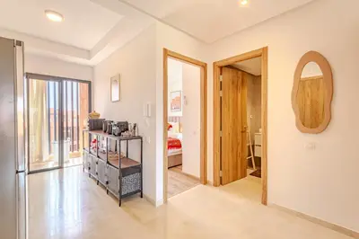 a hallway with a door to a room with a kitchen at Évasion à NORIA - Vue Piscine et Charme Local in Marrakech