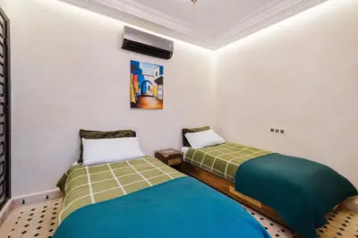 a room with two beds in a room at Riad Emeraude Cozy Riad with Shared Pool 4 Room in Marrakech