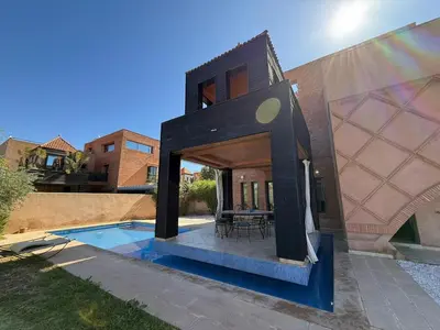 a house with a pool in the backyard at Prestigious Villa in Marrakesh in Marrakech