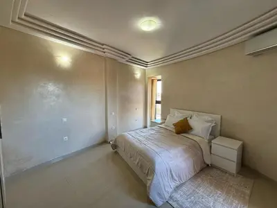 a bedroom with a bed in the corner of a room at Prestigious Villa in Marrakesh in Marrakech