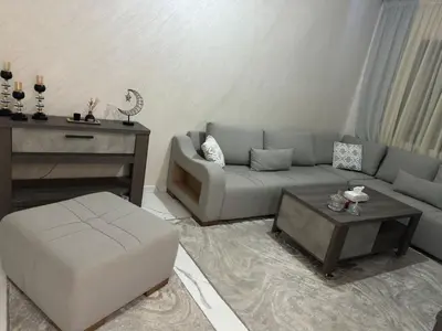 a living room with a couch and a table at Appartement cozy in Marrakech