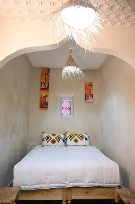 a bedroom with a bed and a chandelier at dar dmana in Marrakech