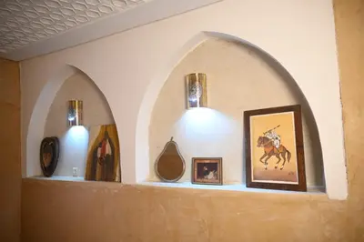 a shelf with a bunch of vases and pictures on it at dar dmana in Marrakech