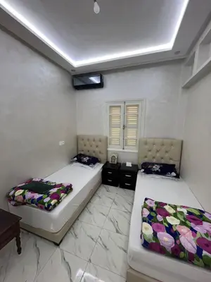two beds in a room with two bedsskirts at Qortoba house in Marrakech