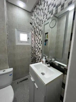 a bathroom with a sink and a toilet and a mirror at Qortoba house in Marrakech