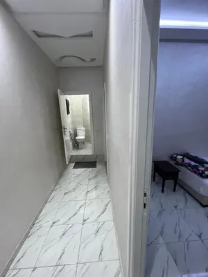 a hallway with a bathroom with a toilet and a room at Qortoba house in Marrakech