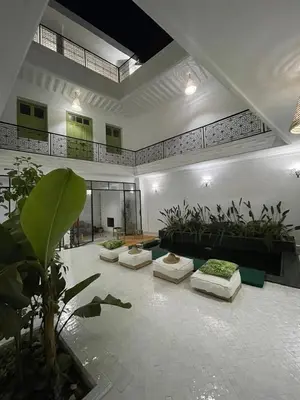 a living room with four couches and plants at Riad de luxe PAMA au cœur de la médina Marrakech in Marrakech