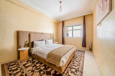 a bedroom with a large bed and a rug at Cocon De Luxe Proche du Centre in Marrakech