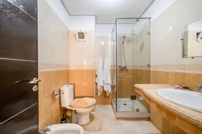 a bathroom with a toilet and a sink and a shower at Cocon De Luxe Proche du Centre in Marrakech