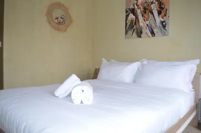 a white bed with two towels on top of it at Golden Palms Marrakech in Marrakech