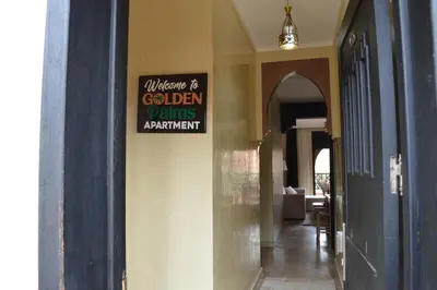 a sign on the side of a building that reads welcome to golden points apartment at Golden Palms Marrakech in Marrakech