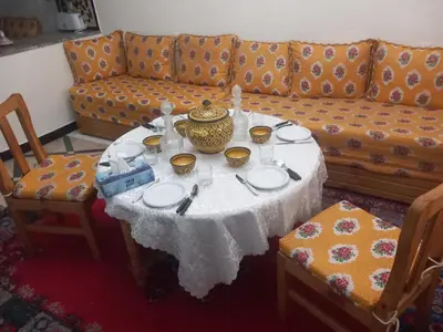 a living room with a table and a couch at Les 3 SOEURS MAJORELLE in Marrakech