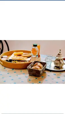 a table with a tray of food and a plate of food at Les 3 SOEURS MAJORELLE in Marrakech