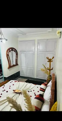 a bedroom with a bed and a mirror at Les 3 SOEURS MAJORELLE in Marrakech
