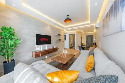 a living room with a couch and a tv at Cosy and fully equipped 2bed appt in Gueliz in Marrakech