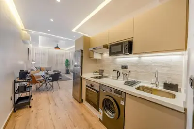 a kitchen with a sink and a washing machine in it at Cosy and fully equipped 2bed appt in Gueliz in Marrakech