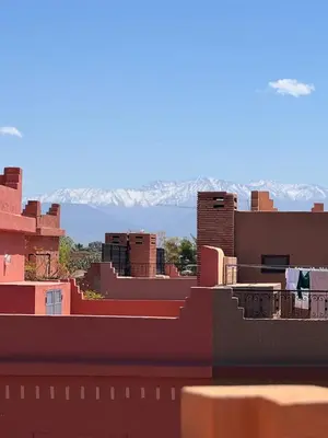 a view of a city with mountains in the background at Magnifique Villa piscine chauffée, cinéma et salle de fitness privés in Marrakech