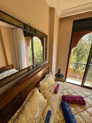a bedroom with a bed and a large mirror at Magnifique Villa piscine chauffée, cinéma et salle de fitness privés in Marrakech