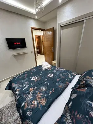 a bedroom with a bed with a blanket on it at Cozy and convenient apartment in Marrakech