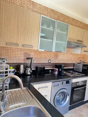 a kitchen with a washing machine and a sink at Villa Oasis Marrakesh in Marrakech
