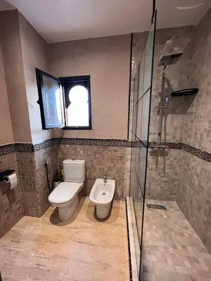 a bathroom with a toilet and a shower at Villa Oasis Marrakesh in Marrakech